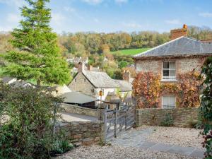 a stone house with a fence in front of it at Wheelwright Cottages in Branscombe +29 photos