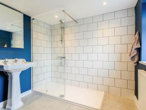 a bathroom with a shower and a sink at Ty Afon in Talybont
