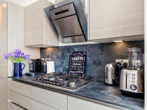 a kitchen with a counter top with a stove top at Formans Lodge in Musselburgh