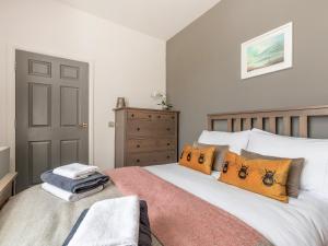 a bedroom with a bed with orange pillows at Formans Lodge in Musselburgh +28 photos