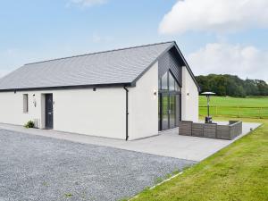 a white house with a black roof at The Byre in Castle Douglas