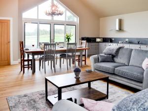 a living room with a couch and a table at The Byre in Castle Douglas
