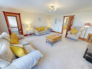 a living room with a couch and a table at Willow Cottage-Uk2788 in Penmaen-mawr