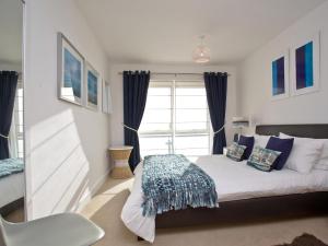 a bedroom with a bed and a window at 42 Ocean 1 in Crantock
