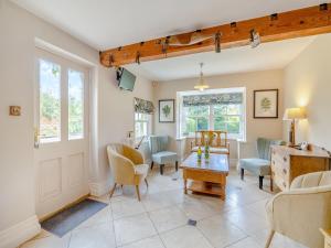 a living room with chairs and a table at The Farmhouse- Uk47148 in Burgh le Marsh