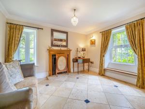 a living room with a fireplace and windows at The Farmhouse- Uk47148 in Burgh le Marsh +26 photos
