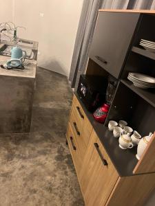 a kitchen with a wooden cabinet with cups on it at MERs house enjoys nature in Cajamarca