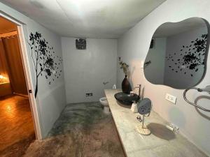 a bathroom with a sink and a mirror at MERs house enjoys nature in Cajamarca +17 photos