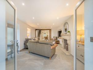 a living room with a couch and a table at Whiteoak Cottage in Rawdon