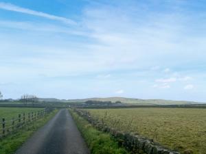 a road in the middle of a field at Whiteoak Cottage in Rawdon