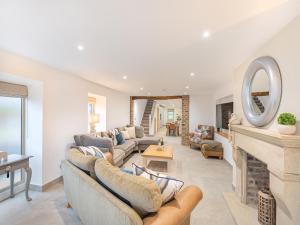 a living room with couches and a fireplace at Whiteoak Cottage in Rawdon +26 photos