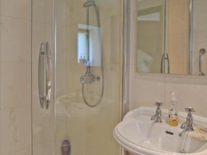 a bathroom with a sink and a shower at Paper Mill Cottage in Sutton +6 photos