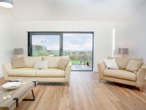 a living room with two couches and a table at Foxglove-Uk34612 in Nether Stowey