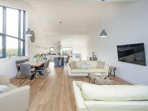 a living room with white furniture and a table at Foxglove-Uk34612 in Nether Stowey