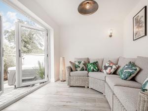 a living room with a couch and a window at Pennyard House in Banwell