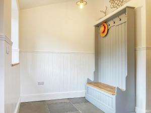 a hallway with a bench in a house at Pennyard House in Banwell