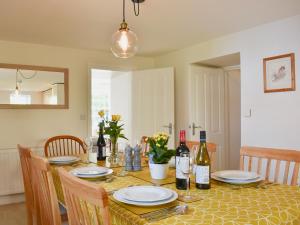 a dining room table with wine bottles and glasses at Brittain House in Richmond
