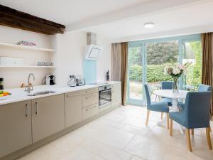 a kitchen with a table and chairs and a dining room at The Hall - Uk32690 in Horton