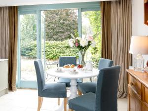 a dining room with a table and chairs and a window at The Hall - Uk32690 in Horton