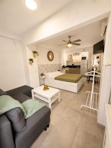 a living room with a couch and a kitchen at Casa rody in Benalmádena +6 photos