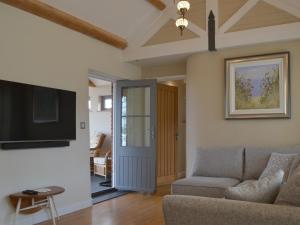 a living room with a couch and a flat screen tv at Trezeal Barn in North Hill