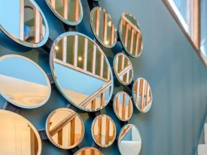 a group of mirrors on the side of a wall at River Test View in Chilbolton +10 photos
