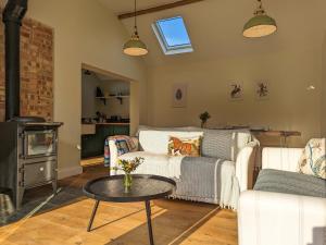 a living room with a couch and a table at The Stables - Uk50804 in Halesworth