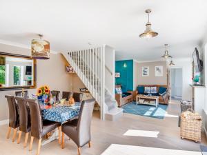 a dining room and living room with a table and chairs at Tregarrek in Coverack