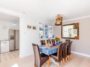 a dining room with a table and chairs at Tregarrek in Coverack