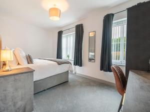 a bedroom with a bed and a window at Sandcastles in Bridlington