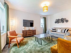 a living room with a couch and a table at Sandcastles in Bridlington