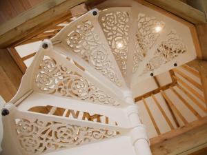 a white staircase in a room with a wooden ceiling at The Barn in Burley
