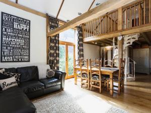 a living room with a couch and a table at The Barn in Burley +5 photos