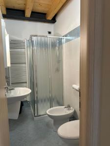 a bathroom with a shower and a toilet and a sink at Locanda Graziella in Moerna +16 photos