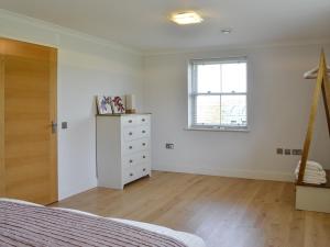 a bedroom with a bed and a dresser and a window at Yonderton House - Uk11181 in Hollybush