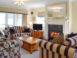 a living room with couches and a fireplace at Yonderton House - Uk11181 in Hollybush