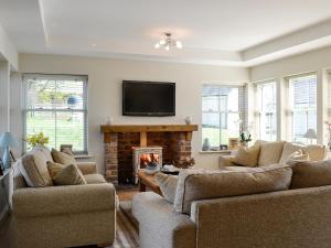 a living room with two couches and a fireplace at Yonderton House - Uk11181 in Hollybush