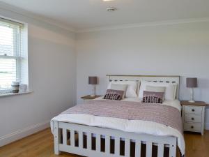a white bedroom with a large bed and a window at Yonderton House - Uk11181 in Hollybush +15 photos
