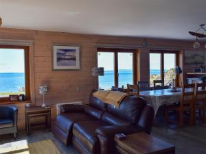 a living room with a couch and a table at Seal Rocks in Lendalfoot