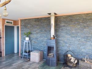 a brick wall with a fireplace in a living room at Seal Rocks in Lendalfoot +20 photos