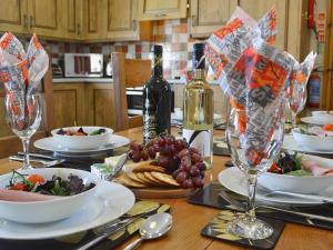 a table with plates of food and a bottle of wine at Eithinog in Talybont