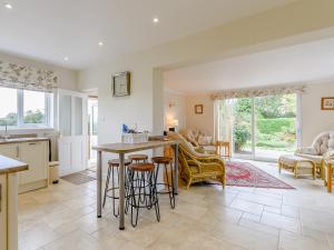a kitchen and living room with a table and chairs at Henrys Retreat in Ingoldsby