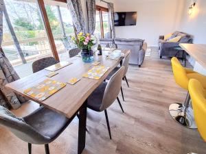 a dining room with a wooden table and chairs at River Breeze-B6853 in Brundall