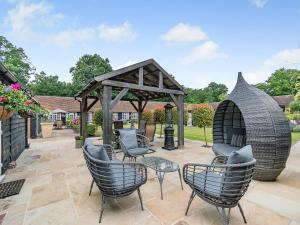 a patio with chairs and a gazebo at The Barn - Uk49371 in Send