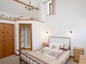 a bedroom with a bed in a room at Swallows Cottage in Parkham