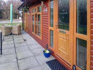 a wooden door on a building with a patio at Stag Lodge in Auchterarder
