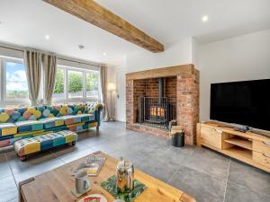 a living room with a couch and a fireplace at Orchard Barns - Uk47200 in Stapleton