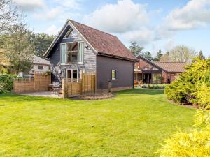 a home with a yard with a house at Granary Barn - Ukc5405 in Banham