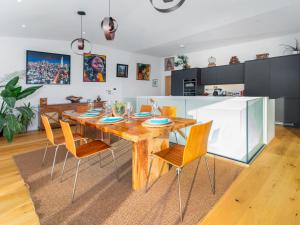 a kitchen and dining room with a wooden table and chairs at Cyan in Mortehoe +23 photos