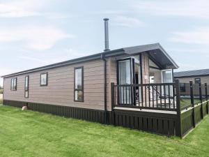 a modular home with a porch and a deck at Transporter Lodge - Ukc4060 in Nunthorpe
